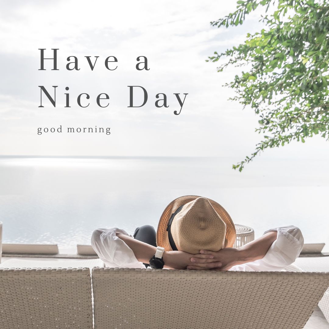 A person wearing a straw hat and white shirt reclines on a wicker sofa, facing a serene body of water under a clear sky. The text "Good Morning" and "Have a Nice Day" is overlaid on the image, with greenery extending from the top right corner.