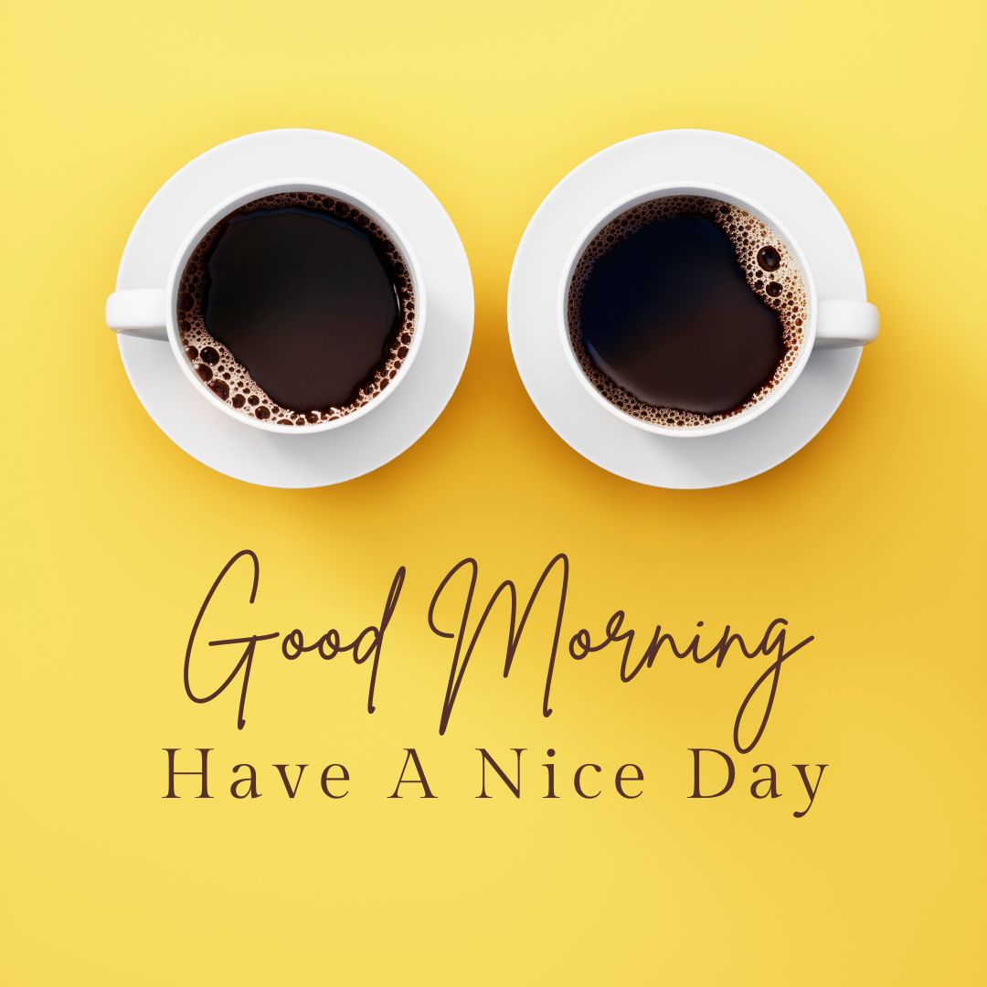 Two coffee cups filled with black coffee on a yellow background, positioned to form the appearance of eyes. Below them, a warm and cheerful message reads "Good Morning Have A Nice Day" in elegant cursive and serif fonts.