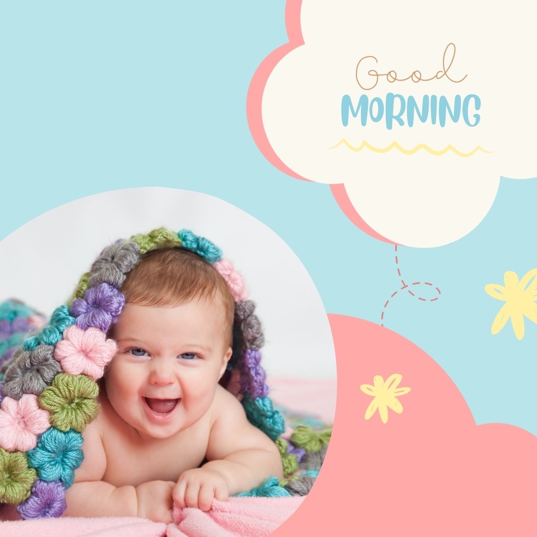 A smiling baby lies under a colorful crocheted blanket, peeking out joyfully. The background is light blue with pink and cream cloud designs, and the words "Good Morning" appear in a cheerful font on a cloud in the upper-right corner—perfect for those seeking Good Morning Baby Images HD.