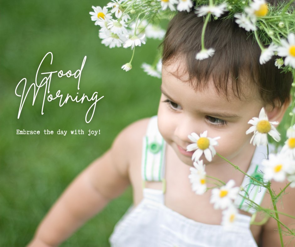 Good Morning Baby Images of a young child adorned with a crown of fresh daisies, gazing thoughtfully while seated on a lush green lawn, with the message 'Good Morning - Embrace the day with joy!'