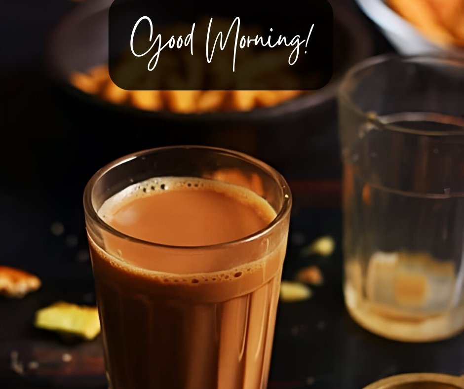 Good morning tea image featuring a tall glass of steaming milk tea, elegantly presented in a dimly lit setting with snacks and a water glass in the background, under the stylish greeting "Good Morning!"