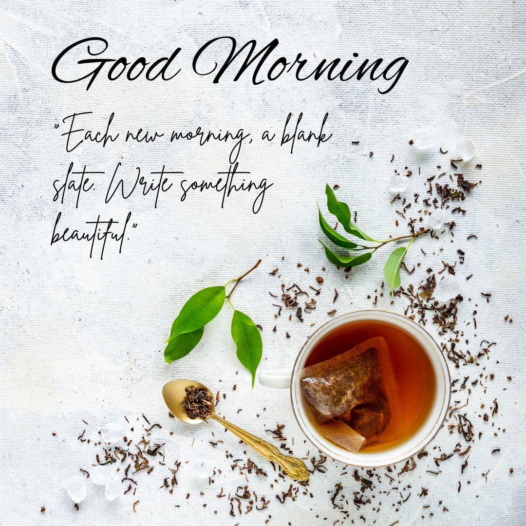 Good morning tea image featuring a cup of tea with a teabag, surrounded by loose tea leaves, a golden spoon, and fresh green leaves on a textured white background, accompanied by the inspirational quote "Each new morning, a blank slate. Write something beautiful."