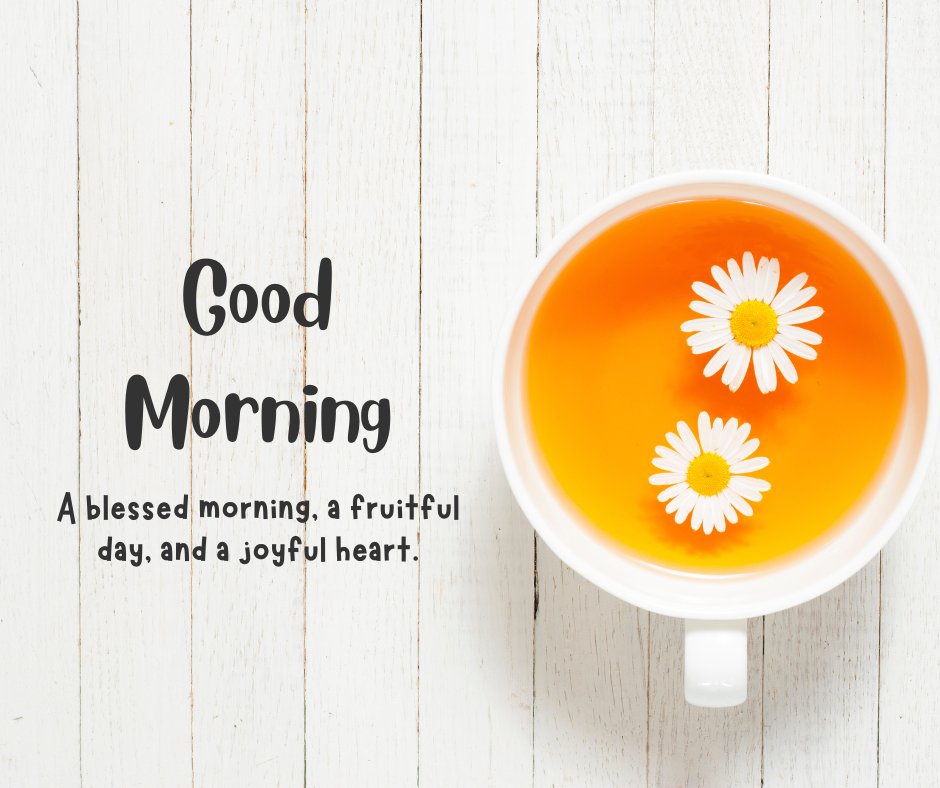 Good morning tea image showcasing a cup of tea with floating daisies, placed on a white wooden background, embodying a peaceful and uplifting start to the day.