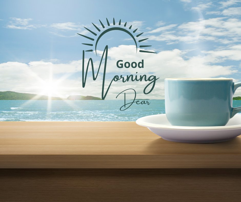 Good morning dear image featuring a serene morning scene with a cup of coffee placed on a wooden table against the backdrop of a sunny beach. The vibrant sun casts a dazzling reflection over the ocean, and the text 'Good Morning Dear' is elegantly styled above, capturing the essence of a peaceful start to the day.