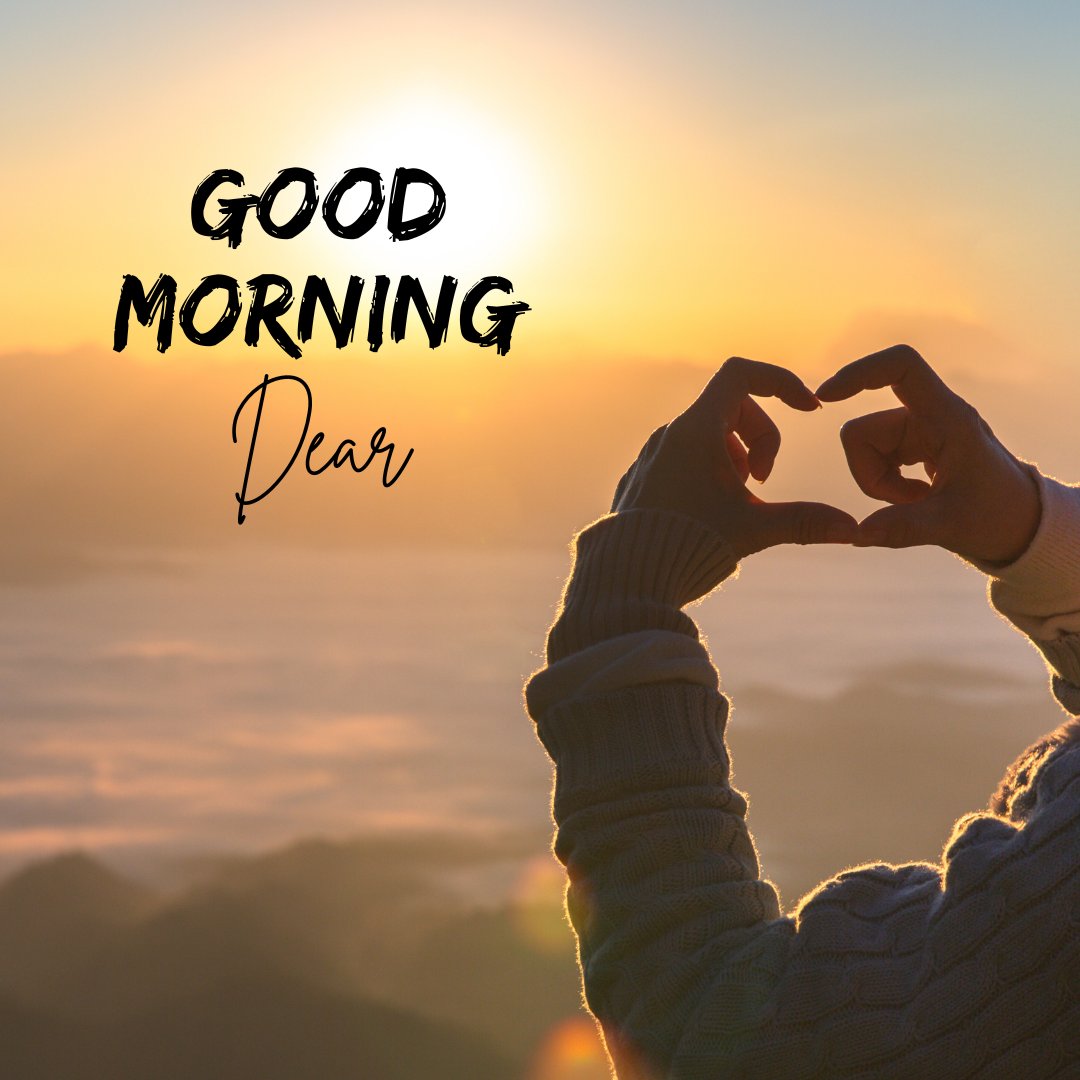 Good morning dear image featuring a silhouette of a person forming a heart shape with their hands against a breathtaking sunrise backdrop, with 'Good Morning Dear' written above in elegant script.