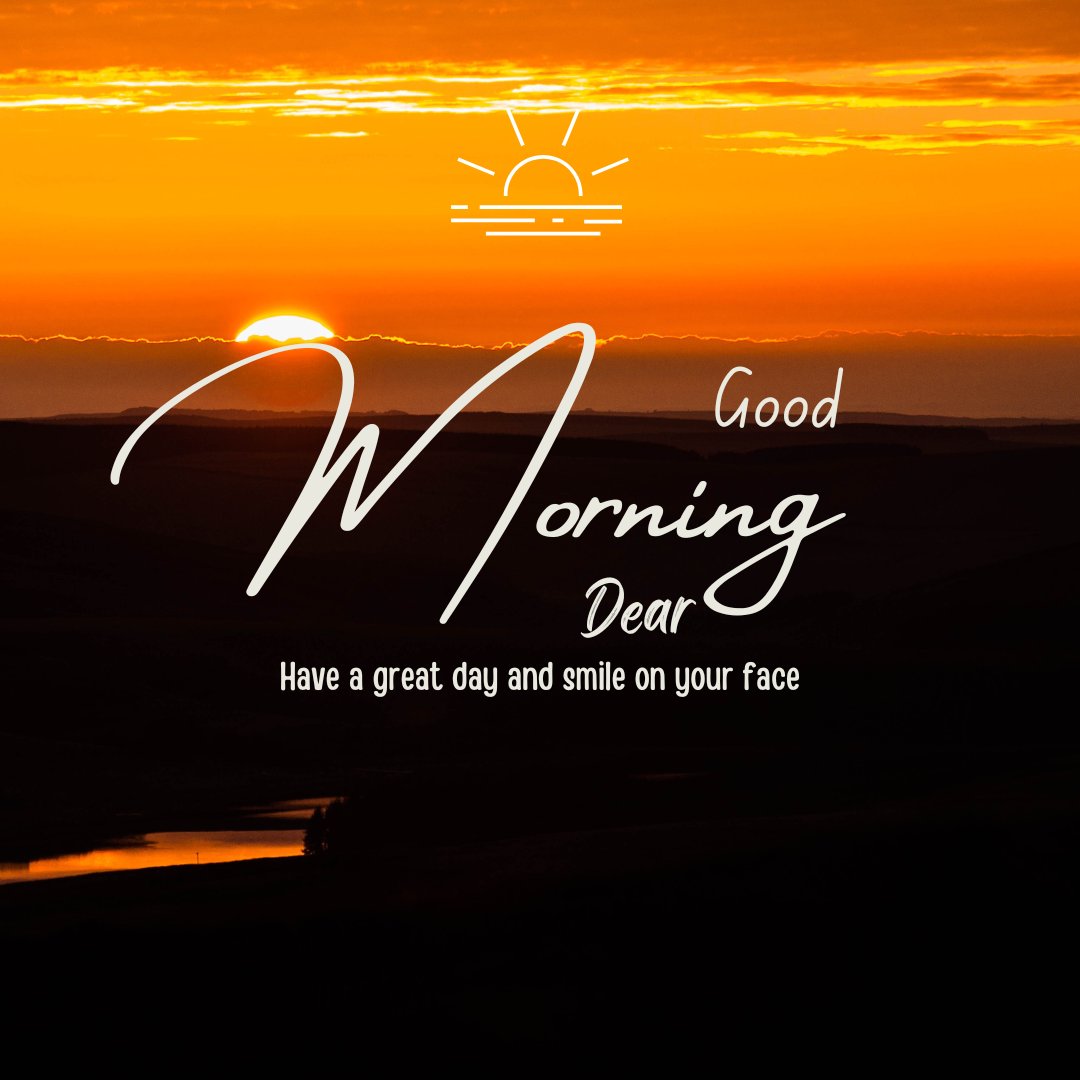 Good morning dear image featuring a stunning sunrise over a tranquil landscape. The horizon glows warmly with orange hues as the sun peeks just above it, casting a golden light. The inspiring message, 'Good Morning Dear, Have a great day and smile on your face,' complements the uplifting scene.