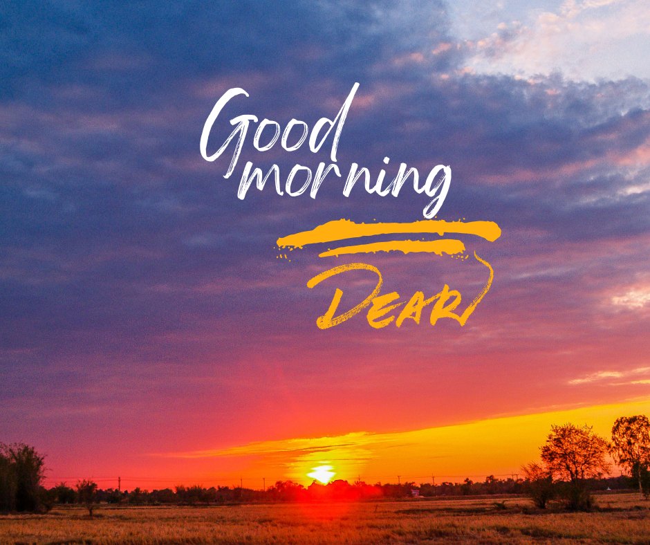 Good morning dear image of a breathtaking sunrise over a serene landscape, with vibrant hues of orange and pink in the sky and the greeting 'Good Morning Dear' stylishly scripted across the top.