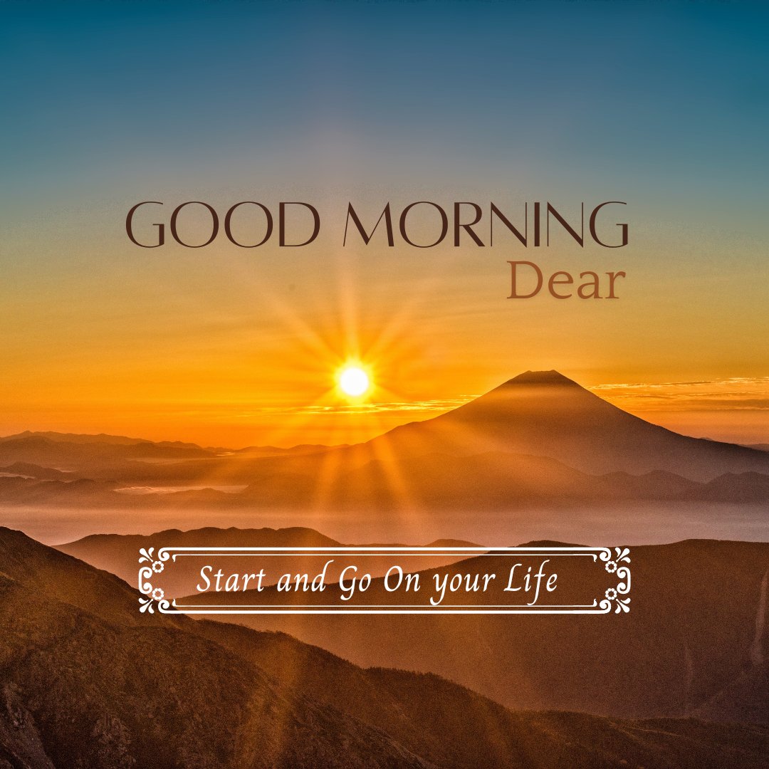 Good morning dear images of a breathtaking sunrise over a mountain range, casting golden hues across the landscape. The sun rises majestically behind a prominent mountain peak, illuminating the morning sky and the rolling hills below, accompanied by inspirational text 'Good Morning Dear - Start and Go On your Life.'