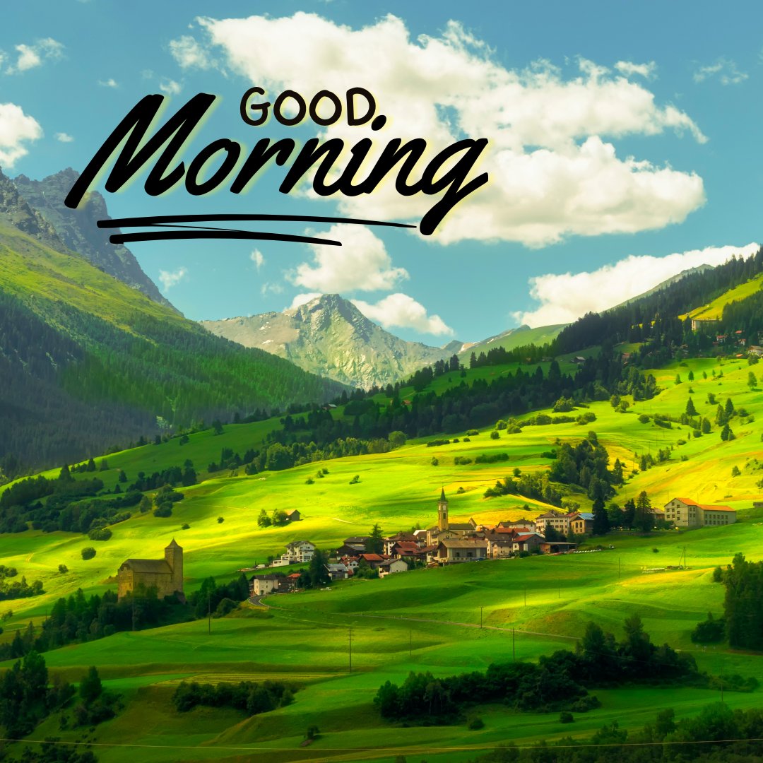 Good morning nature image of a picturesque village nestled in a lush green valley with rolling hills and mountains in the background under a clear blue sky, featuring the greeting "Good Morning.