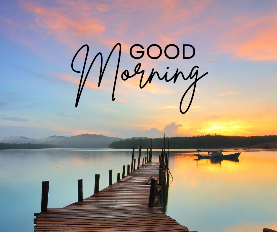 Good morning nature image showcasing a breathtaking sunrise over a tranquil lake, with a wooden dock and boats under a vibrant sky, complemented by elegant 'Good Morning' text.